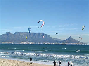 Kite surfing in Table Bay with Table Mountain in the background; another popular water sport off Blouberg's beaches.  Find Blouberg Capetown accommodation convenient for beaches, water sports and views of Table Mountain on our Blouberg Cape Town accommodation page.