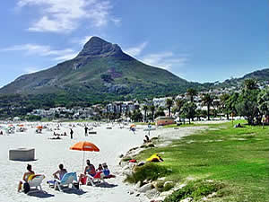 The glorious white sandy beach for which Camps Bay is famous, looking towards Signal Hill.  Find Camps Bay Capetown accommodation with its beaches and sunshine on our Camps Bay Cape Town accommodation page.
