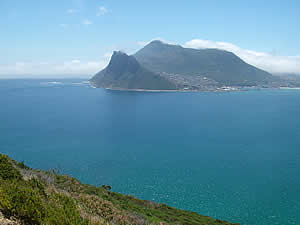 The Sentinel overlooking Hout Bay and the village clustered around the bay and up the hillside.  Find Hout Bay Cape Town accommodation on our Hout Bay Cape Town accommodation page.