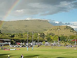 Queenstown is situated between several ranges of mountains.  Here a game of rugby takes place against a backdrop of Long Hill.  Find Queenstown accommodation on our Queenstown accommodation page.