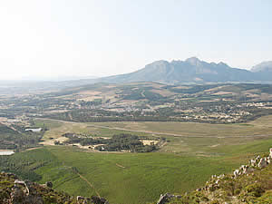 Somerset West and the Helderberg seen from Sir Lowrys Pass, the route out of the Cape over the Hottentots Holland   Mountains into the hinterland.  Find Somerset West accommodation on our Somerset West accommodation page.